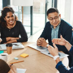 A friendly discussion in a workplace boardroom.