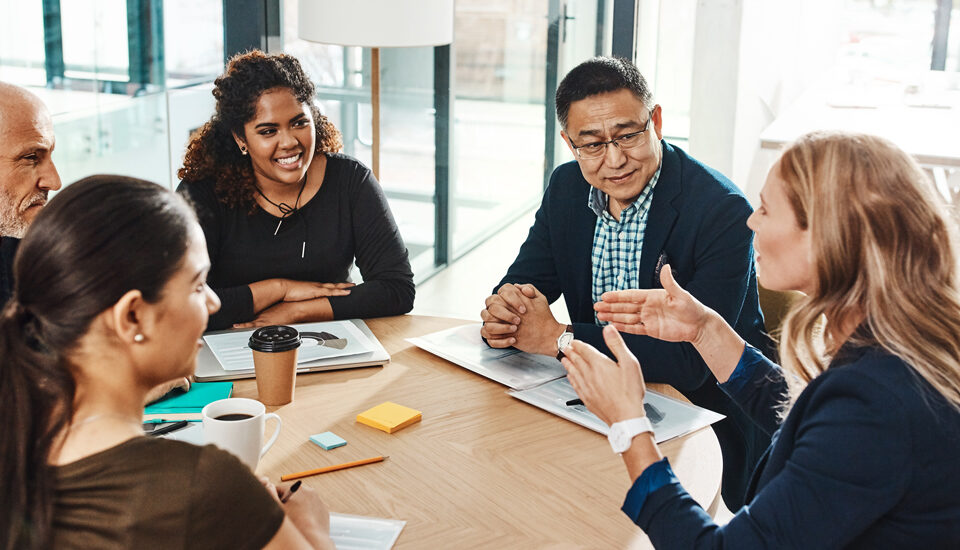 A friendly discussion in a workplace boardroom.