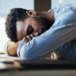 Falling asleep at his desk