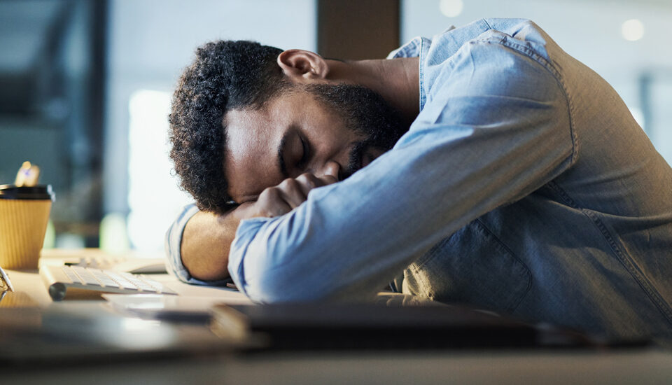 Falling asleep at his desk