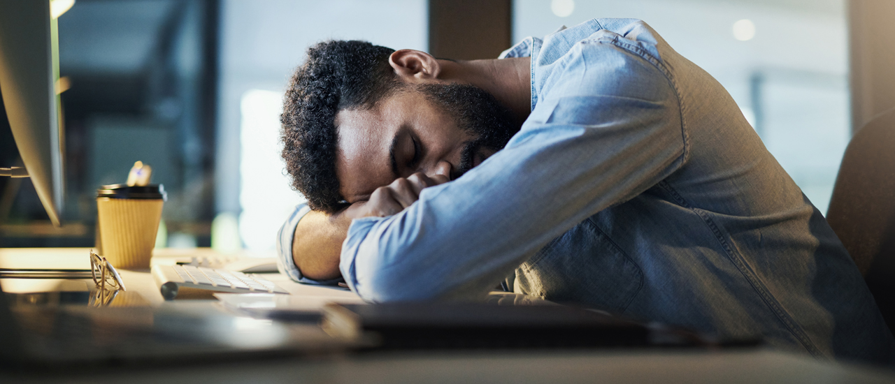 Falling asleep at his desk